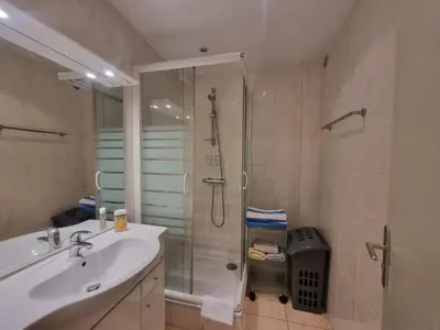 a bathroom with a shower and a sink and a shower at Ferrié Plage Palais Cannes in Cannes