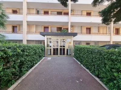 a building with a door in front of it at Ferrié Plage Palais Cannes in Cannes