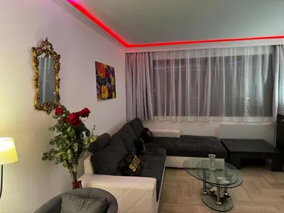 a living room with a couch and a glass table at Gray D'albion Cannes centre , 1 min des plages in Cannes