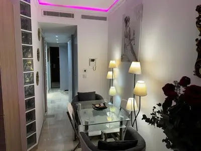 a living room with a glass table and a couch at Gray D'albion Cannes centre , 1 min des plages in Cannes