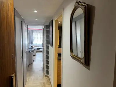 a mirror hanging on a wall next to a hallway at Gray D'albion Cannes centre , 1 min des plages in Cannes