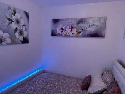 a room with two paintings on the wall and a couch at Gray D'albion Cannes centre , 1 min des plages in Cannes