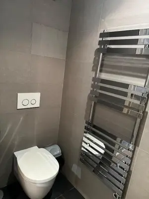 a bathroom with a toilet and a towel rack at Gray D'albion Cannes centre , 1 min des plages in Cannes