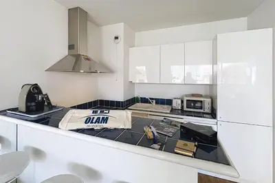 a kitchen with a counter top with a microwave at Cannes central Rue d'Antibes wide 1 BDR w terrace - quiet in green scenery in Cannes