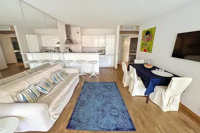 a living room with a couch and a table at Cannes central Rue d'Antibes wide 1 BDR w terrace - quiet in green scenery in Cannes