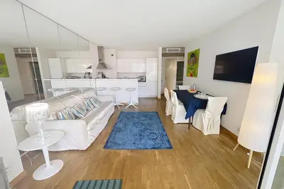 a living room with a couch and a table at Cannes central Rue d'Antibes wide 1 BDR w terrace - quiet in green scenery in Cannes