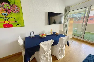 a dining room with a blue table and chairs at Cannes central Rue d'Antibes wide 1 BDR w terrace - quiet in green scenery in Cannes