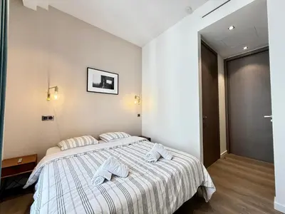 a bedroom with a bed with two towels on it at Carré d'Or - Luxueux - Vue mer in Cannes
