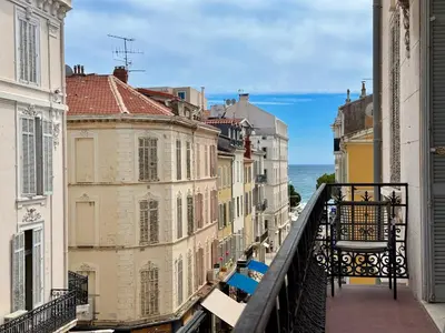 a view from a balcony of buildings and the ocean at Carré d'Or - Luxueux - Vue mer in Cannes