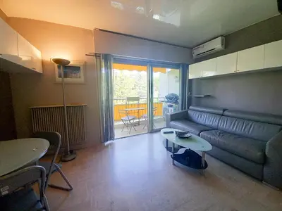 a living room with a couch and a table at Trident G in Cannes