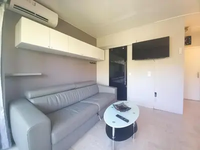 a living room with a couch and a table at Trident G in Cannes