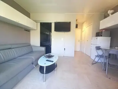a living room with a couch and a table at Trident G in Cannes