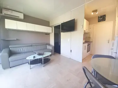 a living room with a couch and a table at Trident G in Cannes
