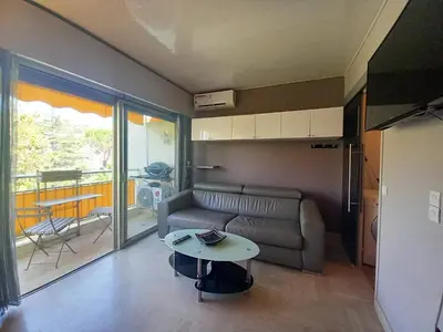 a living room with a couch and a table at Trident G in Cannes