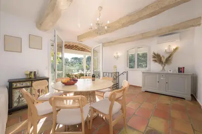 a living room with a couch and a tv at Villa Lou San Peyre in Le Cannet