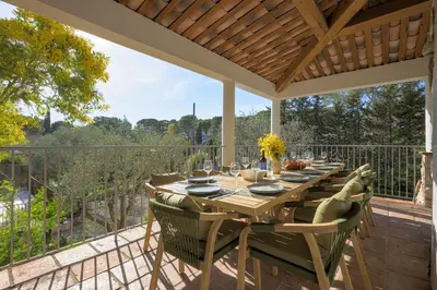 a living room with a table and a couch at Villa Lou San Peyre in Le Cannet