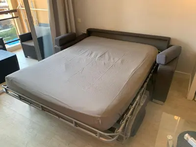 a hospital bed is in a room with a window at 2 pièces vue piscine et plage à 2min in Cannes