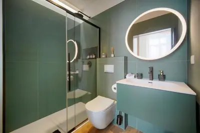 a bathroom with a toilet and a sink and a mirror at Belétage - 5BDR - 4 Bath - Cannes Center - Garage and AC in Cannes