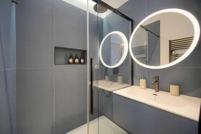 a bathroom with two sinks and a mirror at Belétage - 5BDR - 4 Bath - Cannes Center - Garage and AC in Cannes