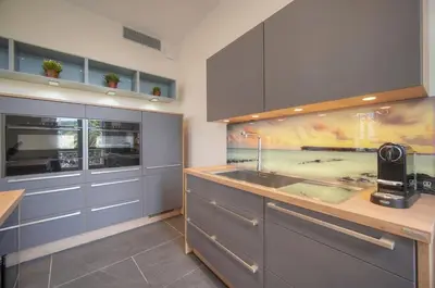a kitchen with a sink and a counter top at Belétage - 5BDR - 4 Bath - Cannes Center - Garage and AC in Cannes