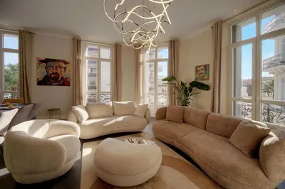 a living room with couches and a chandelier at Belétage - 5BDR - 4 Bath - Cannes Center - Garage and AC in Cannes