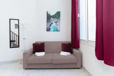 a living room with a couch and a window at Modern 2 Rooms in the heart of Cannes in Cannes