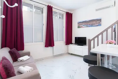 a living room with red curtains and a couch at Modern 2 Rooms in the heart of Cannes in Cannes