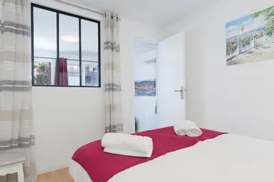 a bedroom with a bed with two towels on it at Modern 2 Rooms in the heart of Cannes in Cannes