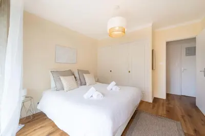 a bedroom with a white bed with towels on it at 1-Br with Terrace Palm Beach Close to Beaches in Cannes