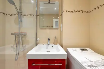 a bathroom with a white sink and a shower at 1-Br with Terrace Palm Beach Close to Beaches in Cannes
