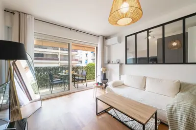 a living room with a couch and a table at 1-Br with Terrace Palm Beach Close to Beaches in Cannes