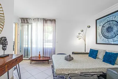 a living room with a couch and a table at Joli deux pièces - Quartier Pointe Croisette - EC in Cannes