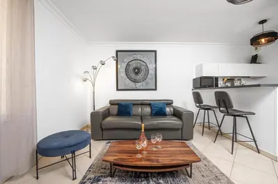 a living room with a couch and a table at Joli deux pièces - Quartier Pointe Croisette - EC in Cannes