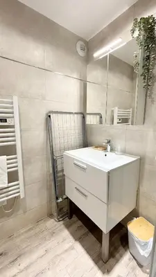 a bathroom with a white sink and a mirror at Proche Palais Des Festivals, T2 avec Mezzanine - Palmazur Vacances in Cannes