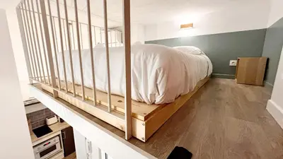 a bedroom with a bed on a wooden platform at Proche Palais Des Festivals, T2 avec Mezzanine - Palmazur Vacances in Cannes
