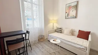 a small living room with a couch and a table at Proche Palais Des Festivals, T2 avec Mezzanine - Palmazur Vacances in Cannes