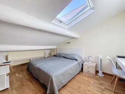 a bedroom with a bed and a skylight at SUPERBE STUDIO Marché Forville in Cannes