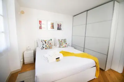 a bedroom with two beds with white walls at Princess Victoria Standing Presta in Cannes