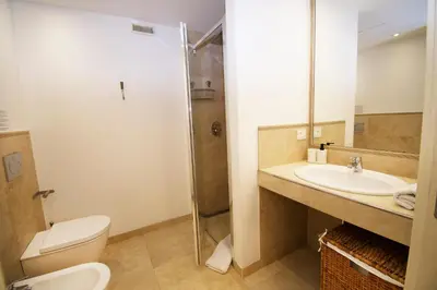 a bathroom with a toilet and a sink and a shower at Princess Victoria Standing Presta in Cannes