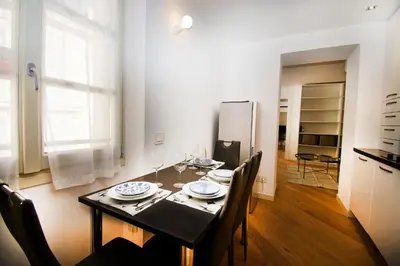 a kitchen and dining room with a table and chairs at Princess Victoria Standing Presta in Cannes