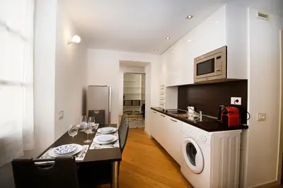 a kitchen with a table and a microwave at Princess Victoria Standing Presta in Cannes