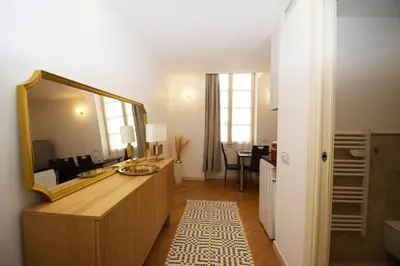 a bathroom with a large mirror and a sink at Princess Victoria Standing Presta in Cannes