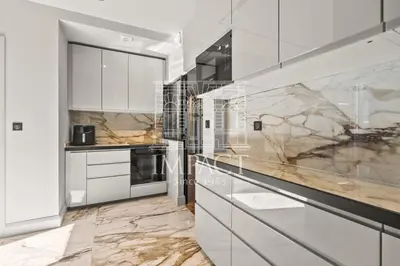 a kitchen with marble counter tops and white cabinets at Cannes Villa - 2167 - Impact Center in Cannes