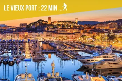 a group of boats docked in a marina at night at 3 Chambres - Central - Plage à 10 min - Lumineux in Cannes