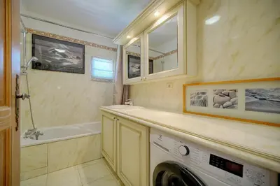 a bathroom with a washing machine and a sink at Lumineux 3 chambres TERRASSE PISCINE PARKING A3B134 in Cannes