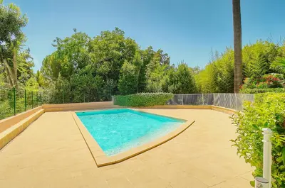 a large swimming pool in a yard with at Lumineux 3 chambres TERRASSE PISCINE PARKING A3B134 in Cannes