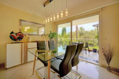 a dining room with a glass table and chairs at Lumineux 3 chambres TERRASSE PISCINE PARKING A3B134 in Cannes