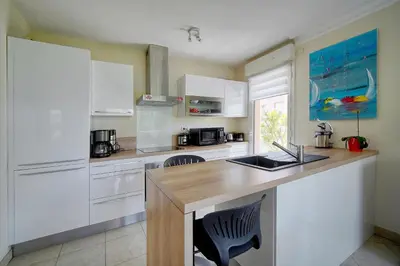 a kitchen with white cabinets and a counter top at Lumineux 3 chambres TERRASSE PISCINE PARKING A3B134 in Cannes