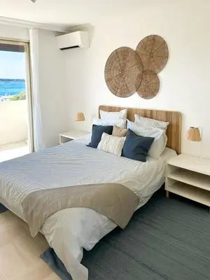 a bedroom with a large bed and a large window at Vue mer - Pointe Croisette - 1 chambre Spacieuse in Cannes