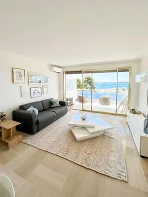 a living room with a couch and a table at Vue mer - Pointe Croisette - 1 chambre Spacieuse in Cannes